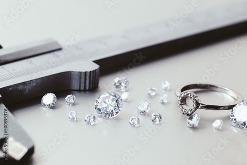 Workplace of a jeweler. Tools and equipment for jewelry work on an metal desktop. Jeweller at work on jewelry made of diamonds. Platinum Diamond Metal Background