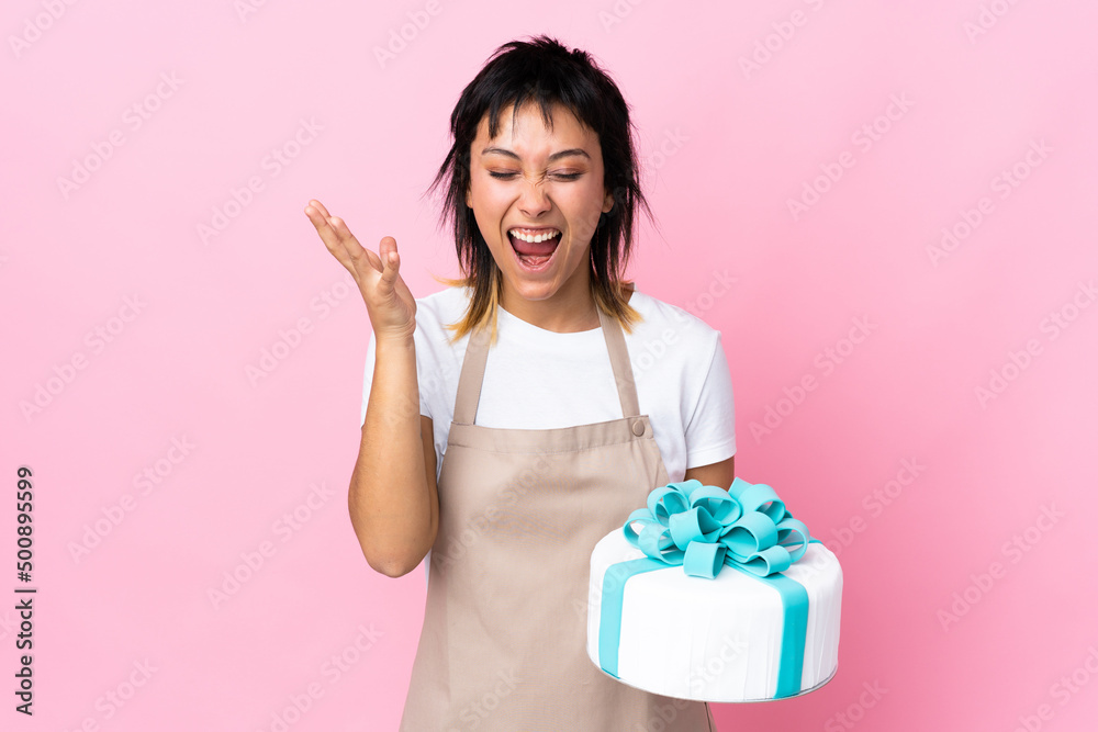 Uruguayan Pastry chef holding a big cake over isolated pink background unhappy and frustrated with something Uruguayan Pastry chef holding a big cake over isolated pink background unhappy and frustrated with something