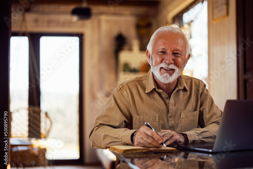 Portrait of a smiling senior man, looking at the camera while wr