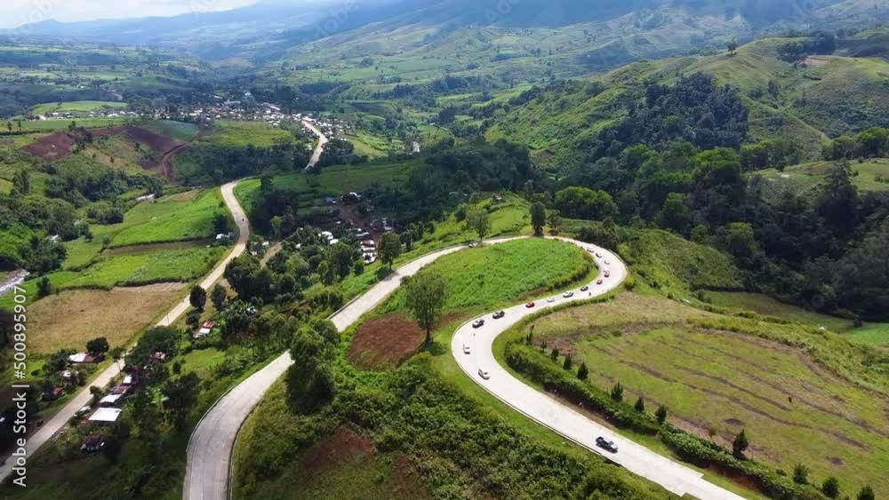 Winding road on a mountain with cars Winding road on a mountain with cars