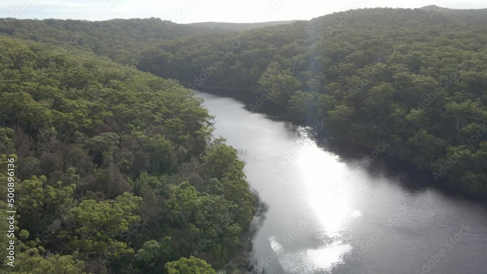 Sunlight Reflection On Blue Lake With Dense Trees On North Stradbroke Island In Queensland, Australia. Aerial Shot Sunlight Reflection On Blue Lake With Dense Trees On North Stradbroke Island In Queensland, Australia. Aerial Shot