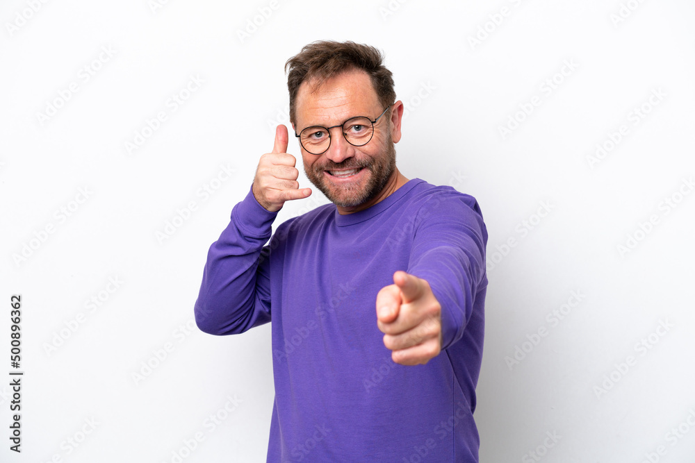 Middle age caucasian man isolated on white background making phone gesture and pointing front Middle age caucasian man isolated on white background making phone gesture and pointing front