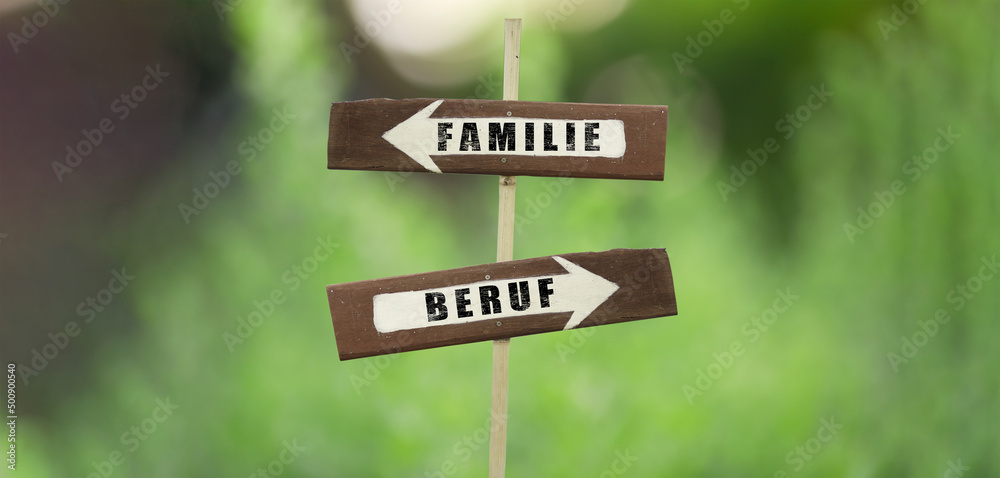 Familie-Beruf on a wooden signpost on a natural green background.copy space.