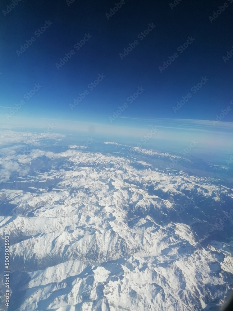 Flying over the snowy alps and mountains of Austria