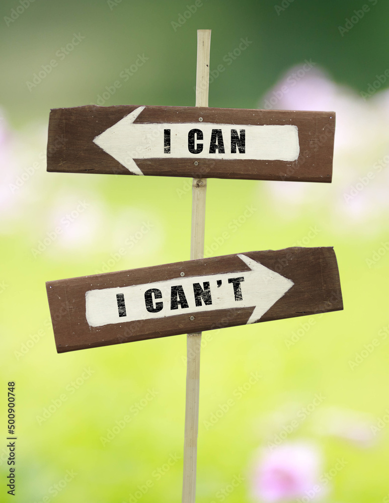 I can - I can't on a wooden signpost on a natural green background.copy space.