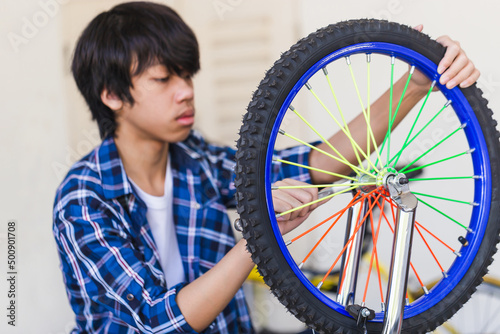 Boy fixing bicycle, Mechanical hobby and repair concepts.