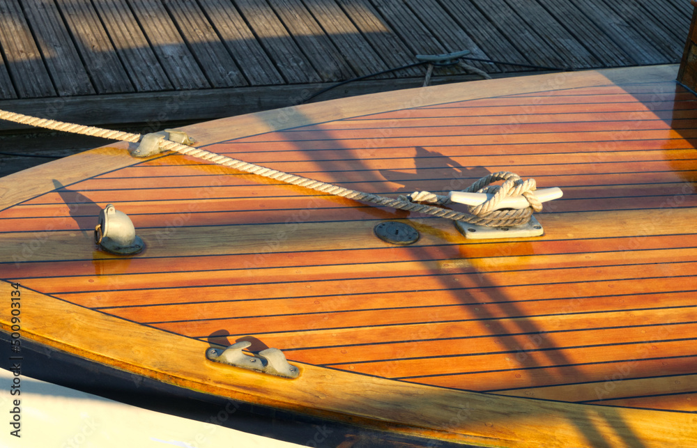 Boat at a wooden dock at harbor. Boat knot equipment. Mooring knot