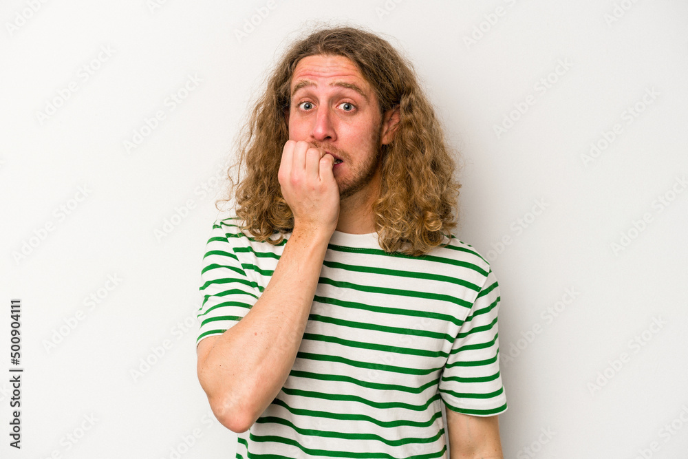 Young caucasian man isolated on white background biting fingernails, nervous and very anxious. Young caucasian man isolated on white background biting fingernails, nervous and very anxious.