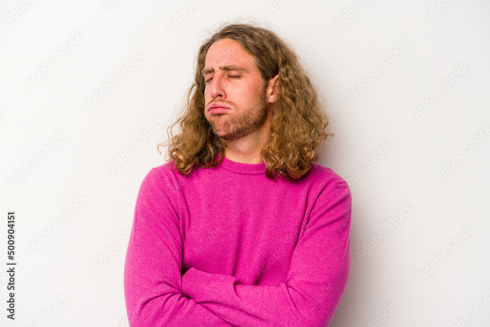 Young caucasian man isolated on white background tired of a repetitive task. Young caucasian man isolated on white background tired of a repetitive task.