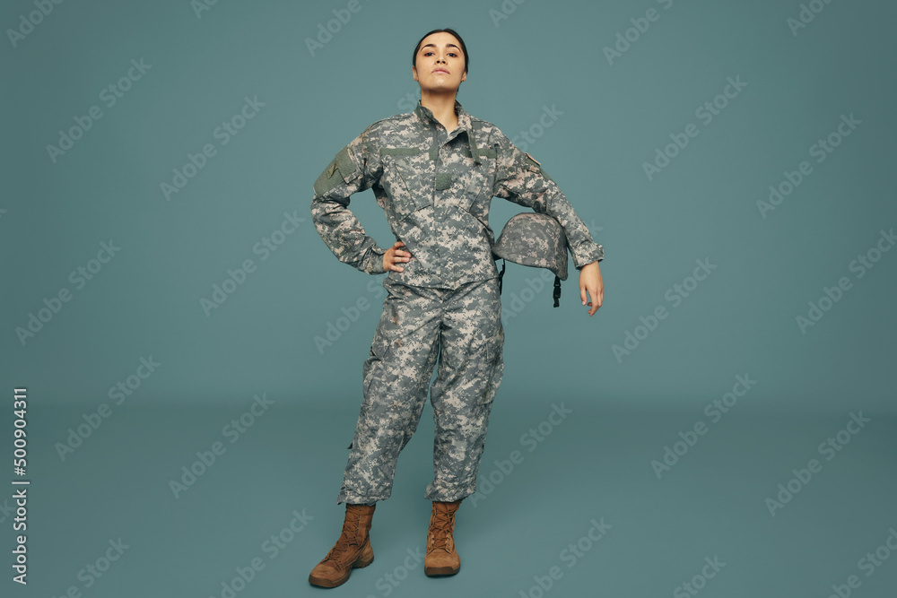 Female army soldier standing strong in a studio Female army soldier standing strong in a studio