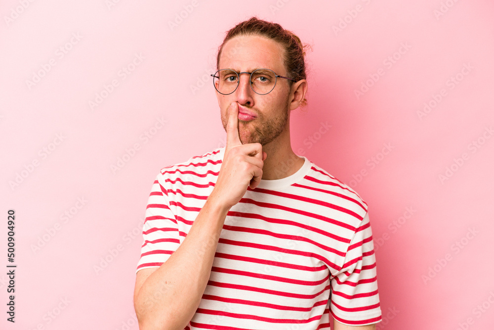 Young caucasian man isolated on pink background thinking and looking up, being reflective, contemplating, having a fantasy. Young caucasian man isolated on pink background thinking and looking up, being reflective, contemplating, having a fantasy.