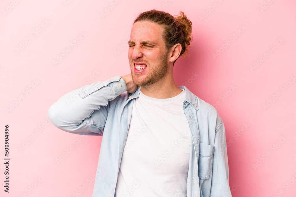 Young caucasian man isolated on pink background suffering neck pain due to sedentary lifestyle. Young caucasian man isolated on pink background suffering neck pain due to sedentary lifestyle.