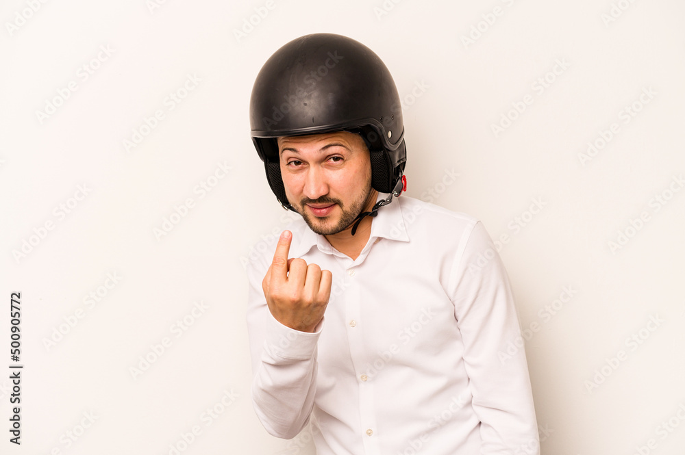 Hispanic business man going to work with motorcycle isolated on white background pointing with finger at you as if inviting come closer. Hispanic business man going to work with motorcycle isolated on white background pointing with finger at you as if inviting come closer.