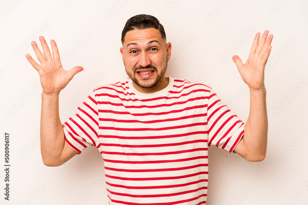 Young hispanic man isolated on white background screaming to the sky, looking up, frustrated. Young hispanic man isolated on white background screaming to the sky, looking up, frustrated.