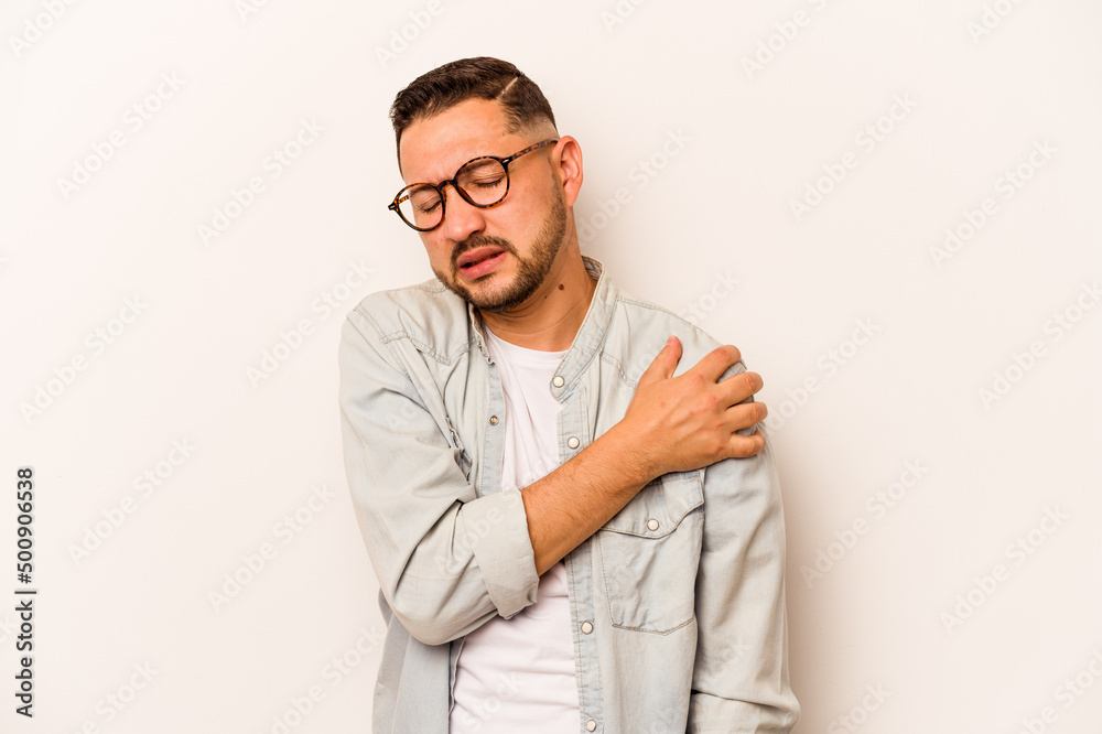 Young hispanic man isolated on white background having a shoulder pain. Young hispanic man isolated on white background having a shoulder pain.