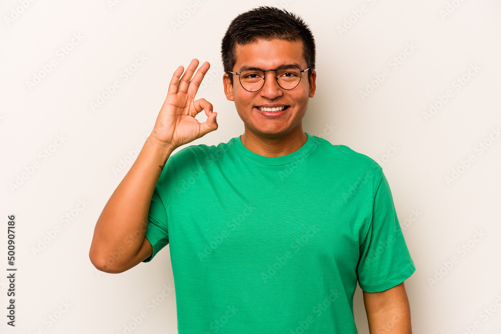 Young hispanic man isolated on white background cheerful and confident showing ok gesture. Young hispanic man isolated on white background cheerful and confident showing ok gesture.