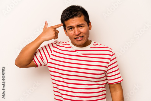 Young hispanic man isolated on white background showing a disappointment gesture with forefinger.