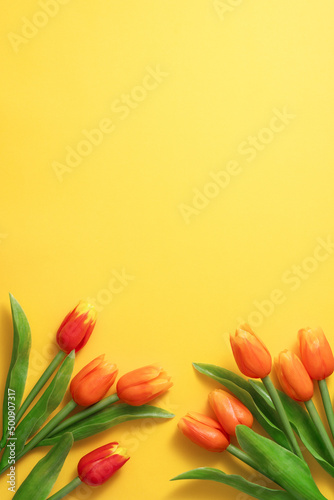 Mother's day background concept. Top view design of holiday greeting tulip flower bouquet on bright yellow table