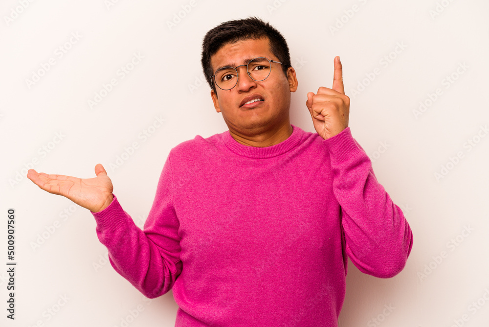 Young hispanic man isolated on white background holding and showing a product on hand. Young hispanic man isolated on white background holding and showing a product on hand.