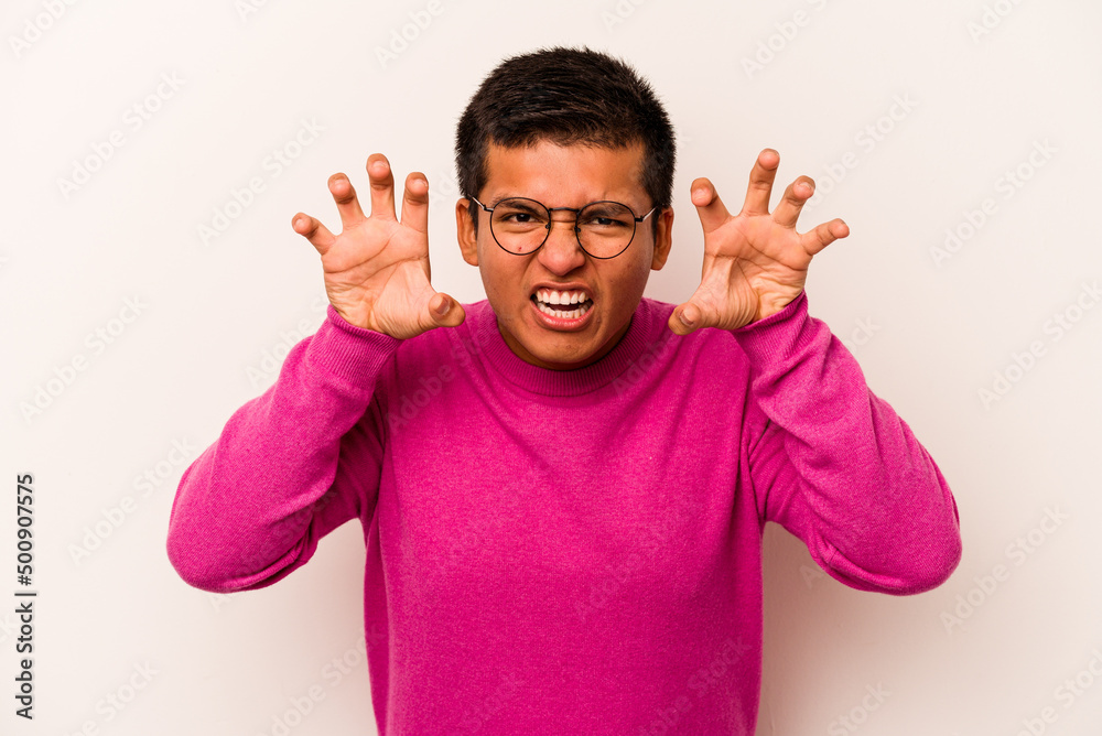 Young hispanic man isolated on white background showing claws imitating a cat, aggressive gesture. Young hispanic man isolated on white background showing claws imitating a cat, aggressive gesture.