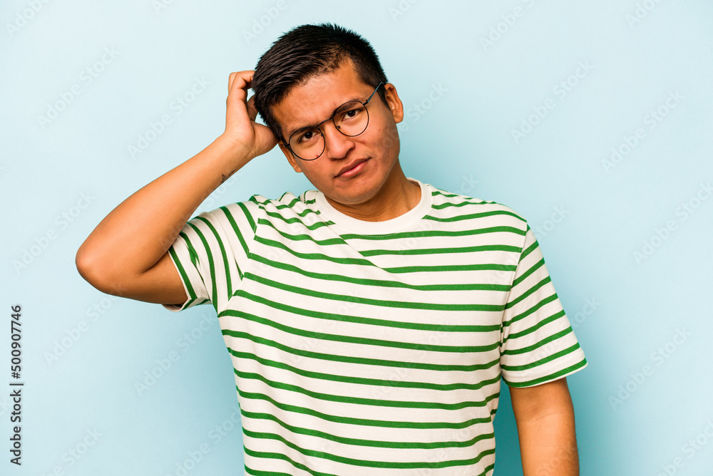 Young hispanic man isolated on blue background tired and very sleepy keeping hand on head. Young hispanic man isolated on blue background tired and very sleepy keeping hand on head.