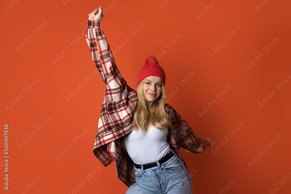 portrait of a cute dancing woman with her hands raised up