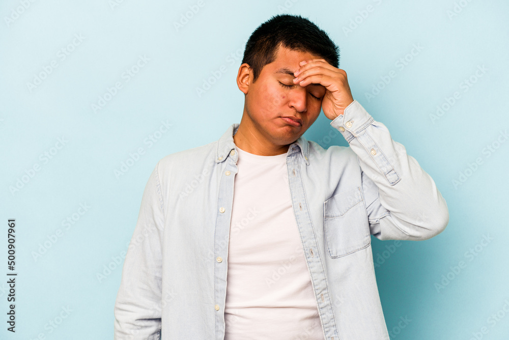 Young hispanic man isolated on blue background touching temples and having headache. Young hispanic man isolated on blue background touching temples and having headache.
