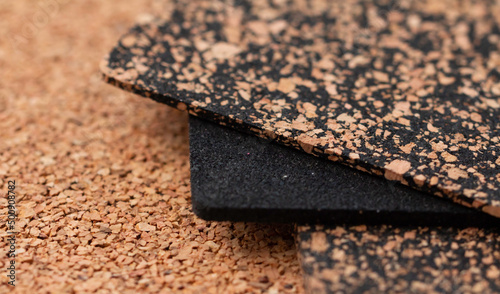A close-up of a rubberized and rubberless cork plate with a shallow depth of field