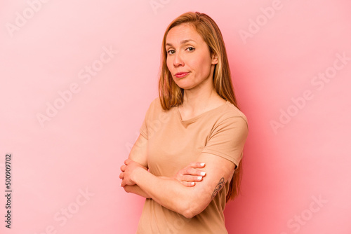 Wallpaper Mural Young caucasian woman isolated on pink background suspicious, uncertain, examining you. Torontodigital.ca