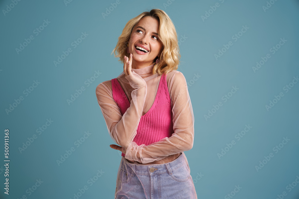 Young white woman with blonde hair laughing and looking aside