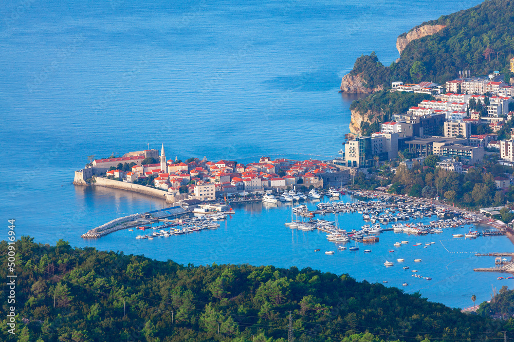 Old town and beach of Budva, Montenegro . Aerial view of coastal town 
