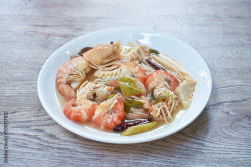 boiled river shrimp with herb in Thai spicy soup or tom yum kung on plate