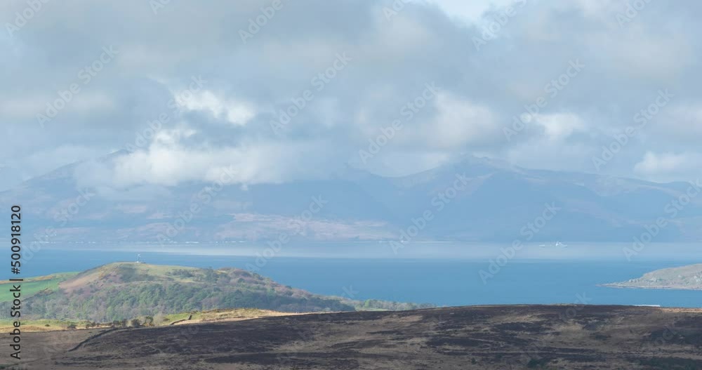 The Isle of Arran Mountains on the West Coast of Scotland in Late spring with rolling clouds and mist over goat fell giving a dramatic motion effect. From Fairlie Moor on the west coast.
The Isle of Arran Mountains on the West Coast of Scotland in Late spring with rolling clouds and mist over goat fell giving a dramatic motion effect. From Fairlie Moor on the west coast.