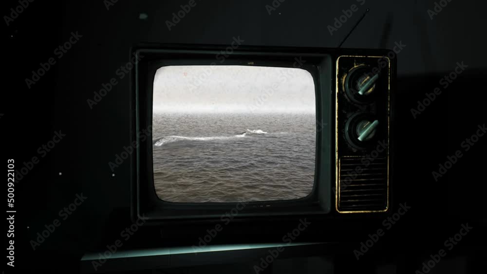 A survivalist in a hazmat suit watches the apocalypse live on TV in a ...