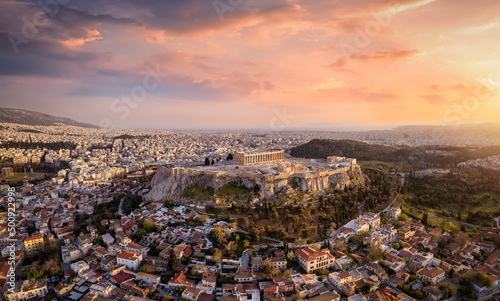 Beautiful, panoramic view of the Acropolis of Athens, Greece, with the Parthenon Temple and the old town Plaka during a colorful summer sunset © moofushi