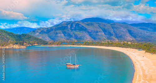 Fototapeta Naklejka Na Ścianę i Meble -  Brown gulet anchored at the Aegean sea - Panoramic view of Oludeniz Beach And Blue Lagoon, Oludeniz beach is best beaches in Turkey - Fethiye, Turkey