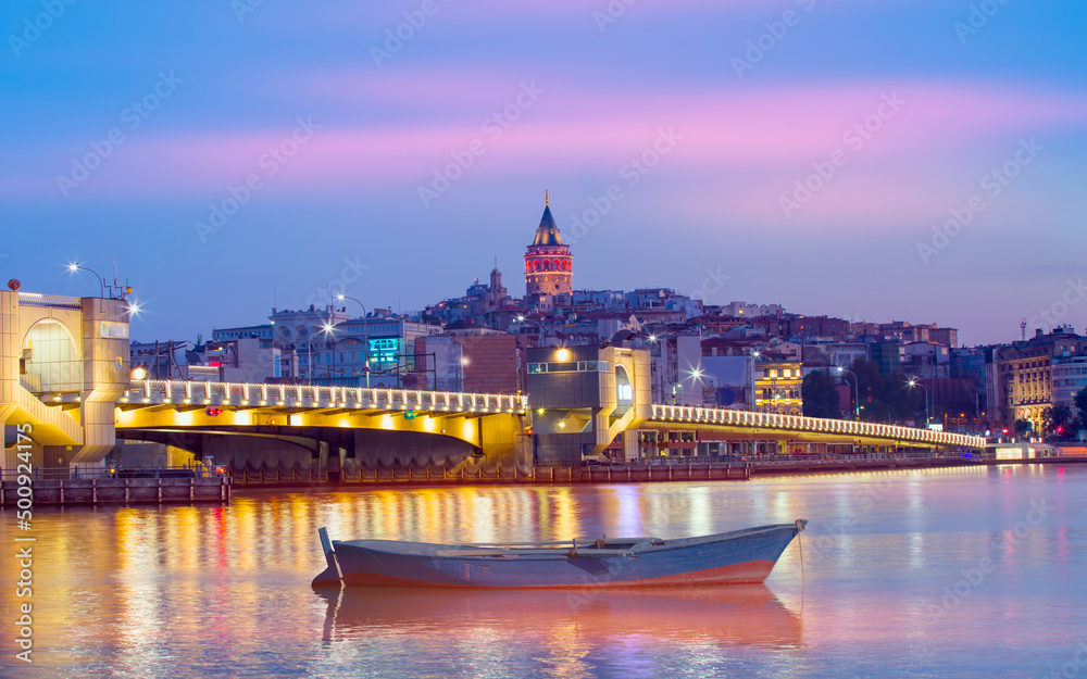 Galata Tower, Galata Bridge, Karakoy district and Golden Horn at morning with Closeup of wooden small boat floating on the sea - istanbul - Turkey