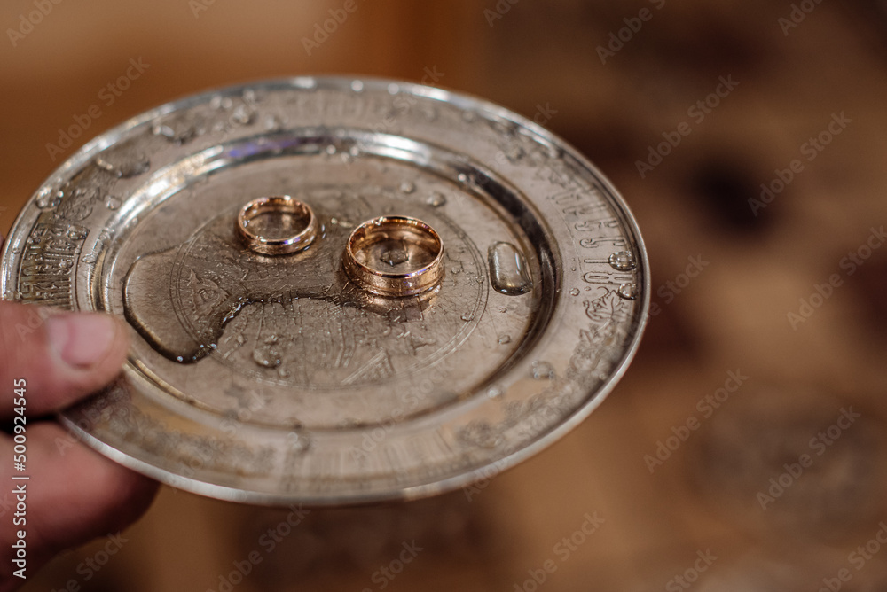 A silver tray with wedding rings at the church A silver tray with wedding rings at the church
