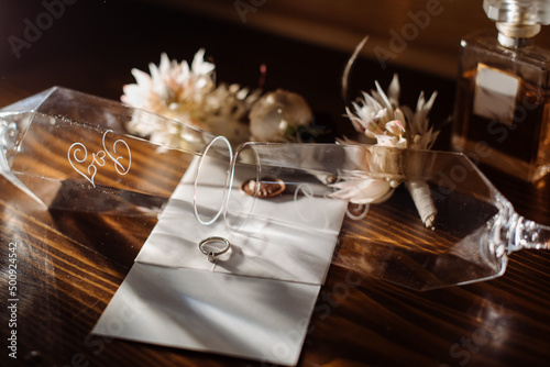 Brides wedding accesories, ring, bouquets and invitation card on flat lay wedding day