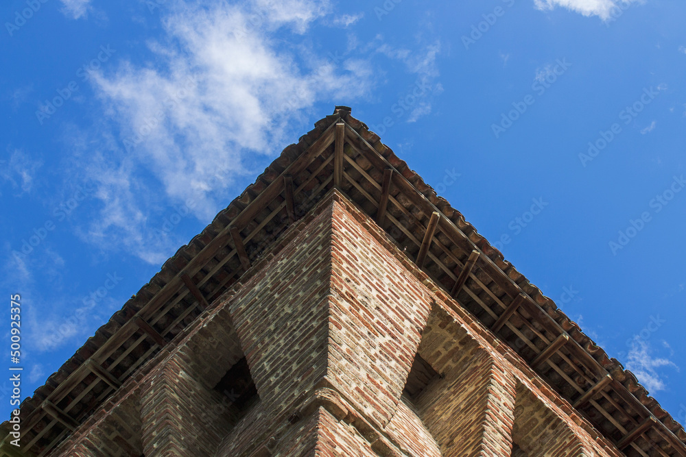 Low angle view of an ancient building against sky and clouds. Perspective, geometric shape, Copy space. Low angle view of an ancient building against sky and clouds. Perspective, geometric shape, Copy space.
