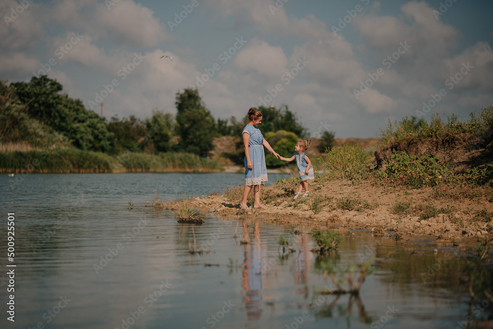 Mother and daughter playing on the lake Mother and daughter playing on the lake
