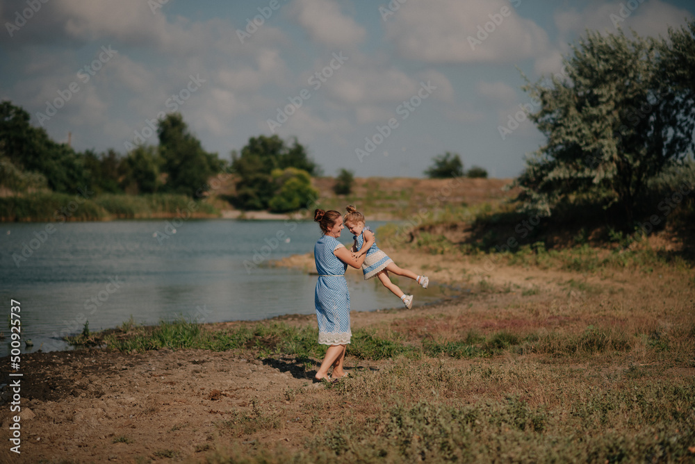 Mother and daughter playing on the lake