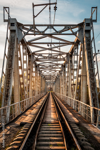 Fototapeta Naklejka Na Ścianę i Meble -  symmetrical railway bridge on sunset