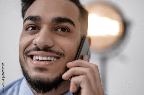A smiling young businessman with a phone