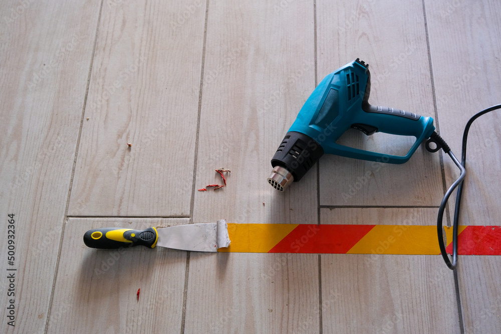 heat gun and spatula for removing marker tape from ground Stock Photo