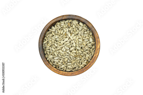 Sunflower seeds in wooden bowl isolated on white background top view