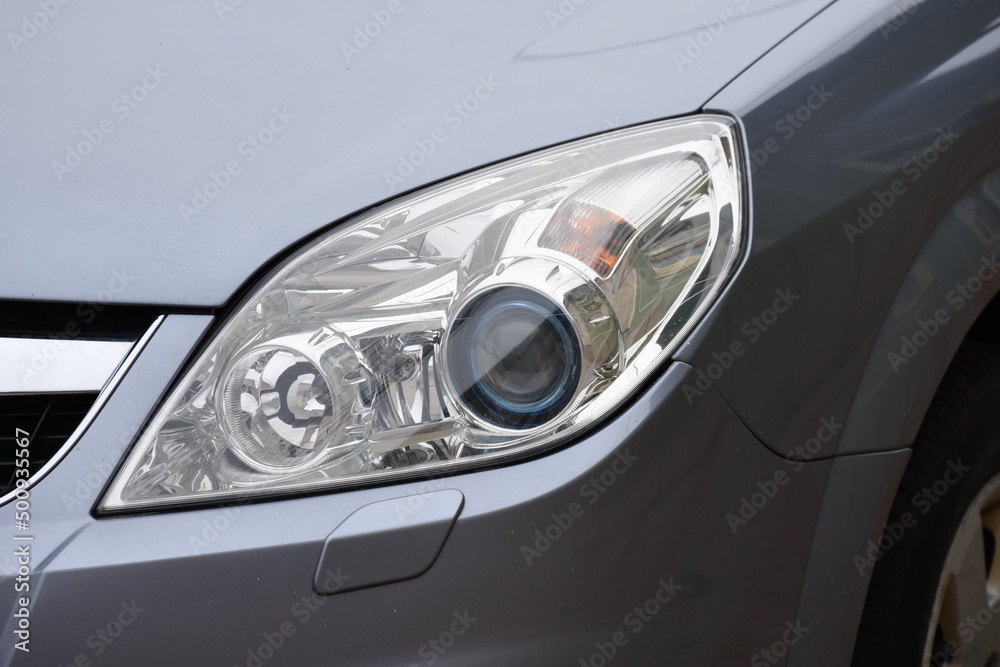 Car's exterior details.Blue car - headlight on gray   car