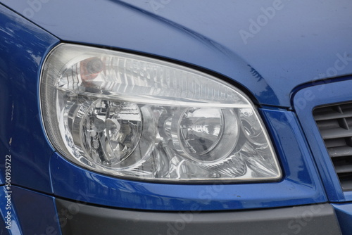 shiny headlight on a blue car