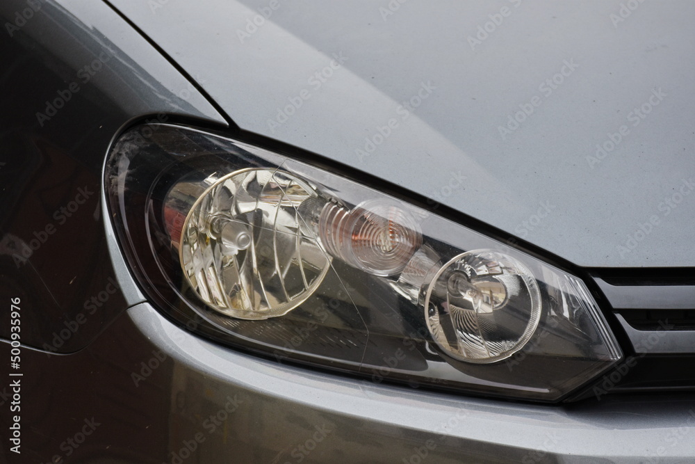 Car's exterior detail,new headlight on a  white silver car