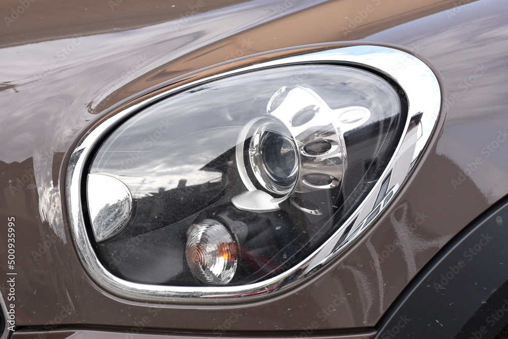 shiny headlights on a gray car